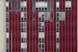 Red and white building facade with glass windows